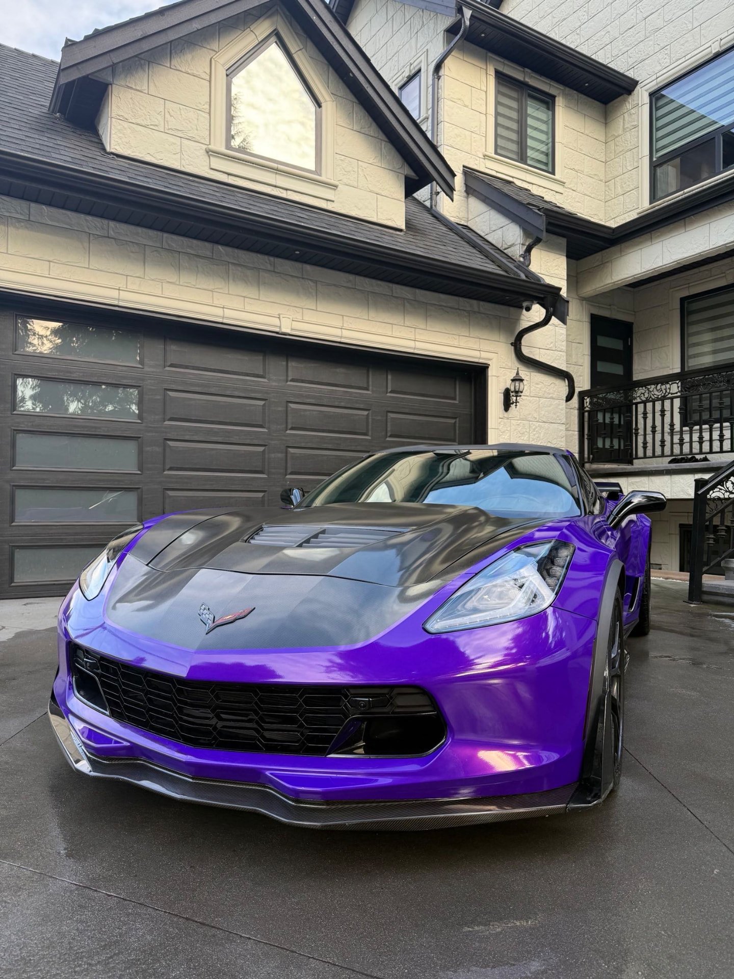 Purple Chevrolet Corvette detailed in a driveway